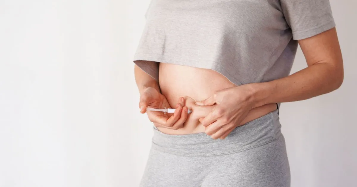 Woman administering Weight Loss Injection into abdomen in Katy, TX